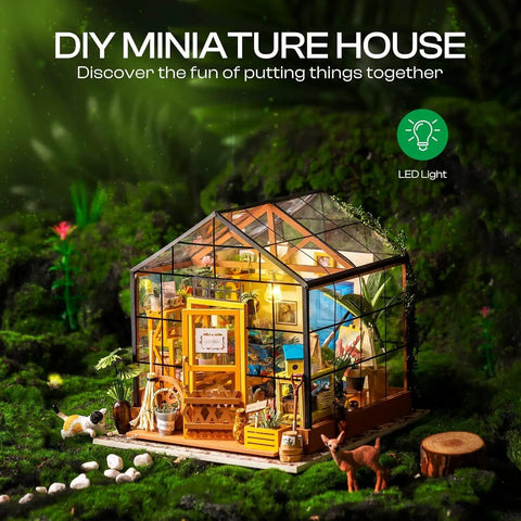 DIY Miniature Greenhouse Kit With Dope LED Lights 1 To 24 Scale Wooden Dollhouse With Realistic Furniture Gift For Adults Cathy's Greenhouse Edition Cozy Home Craft Project showcasing illuminated glass structure in forest setting.