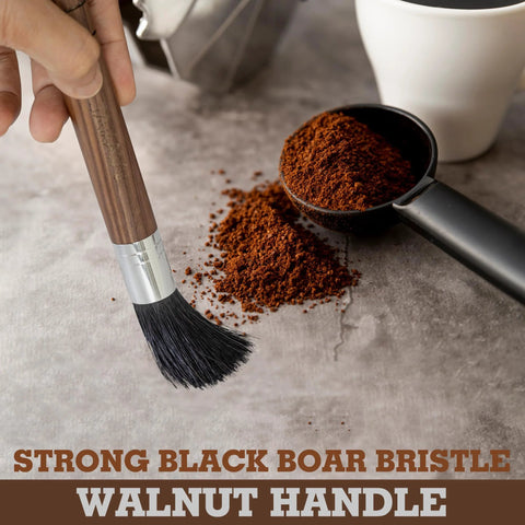 Takavu coffee grinder cleaning brush with walnut handle and black boar bristles beside ground coffee and scoop