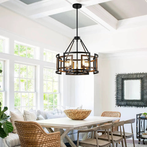 Twenty Inch Five Light Farmhouse Chandelier Featuring Walnut Wood And Matte Black Metal above a dining table in a bright room.
