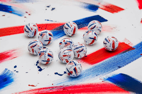 SpeedSoft Ink USA Dozen Soft Golf Balls With Ultra Low Compression PWRCORE Technology displayed on painted surface