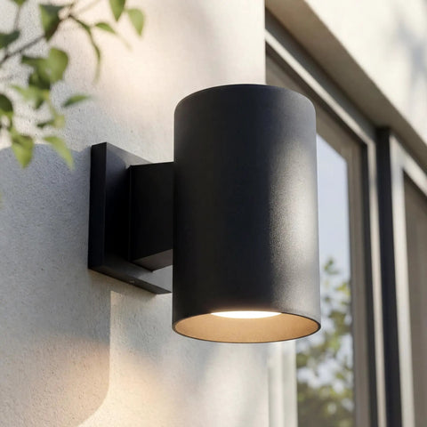 5 Inch Black Modern Outdoor Wall Lantern Light for Patio and Exterior, mounted on a wall, cylindrical design, weatherproof aluminum housing