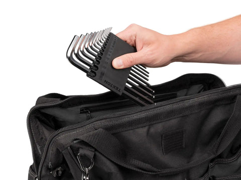 Ball End Hex Key Set, 13-Piece For Off-Center Access With Chamfered Ends being placed in a black tool bag by hand.