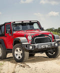 Heavy Duty UV-Resistant Waterproof Winch Cover For Electric Winches 8K To 13.5K Lbs on red Jeep in outdoor setting.