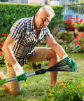 Man using Adjustable Leaf Rake And 9 Tine Cultivator Tool With 49 2 Inch Aluminum And Rubber Handle For Flower Beds Shrubs And Courtyard Gardens Wall Hangable Storage And Extendable Pole From 30 To 40 Inches For Back Saving Garden Work in a garden.