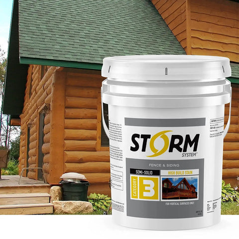 Legit Semi Solid Exterior Wood Stain And Weather Resistant Topcoat In Deep Butternut Tones Easy Brush Application Five Gallon Tub next to wooden deck and log cabin.