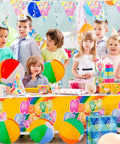 Children at a party with Beach Balls Bulk 12 Pack 9 Inch Inflatable Pool Toys For Kids Summer Water Games on display.