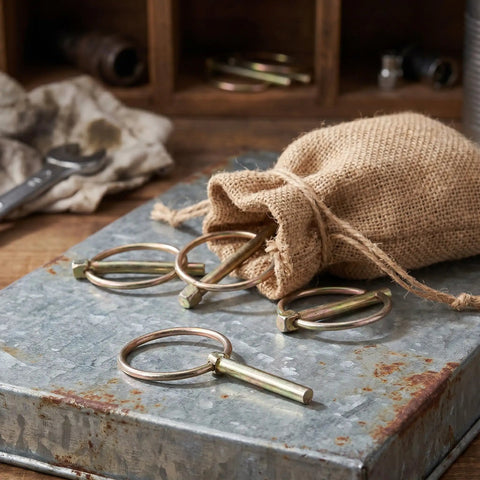Get Your Yard Gear Fixin' With These 12 Heavy Duty Carbon Steel Retaining Pins in a burlap sack on a metal surface.