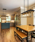 Industrial Farmhouse Black Pendant Light Five Lights For Kitchen Island And Dining Space hanging over rustic dining table.