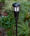 4 Pack Solar Powered Flickering Flame Outdoor Island Torches With Realistic Dancing Flame LED in garden setting