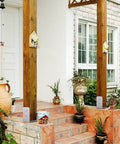 Front porch with 2 Pack 4x4 Post Base Adjustable Stainless Steel Anchor For Concrete Decks And Railings supporting wooden posts.