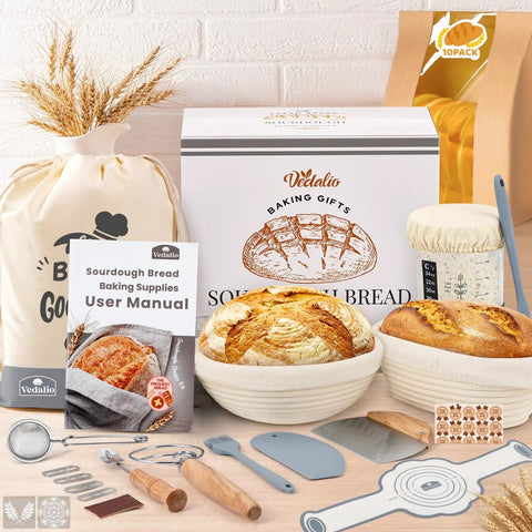 All In One Sourdough Starter Kit For Home Bakers With Round 9 Inch And Oval 10 Inch Proofing Baskets Bread Jar Silicone Spatula Dough Whisk Bread Lame And Blades Blade Cover And Mixing Bowl set displayed on a table.