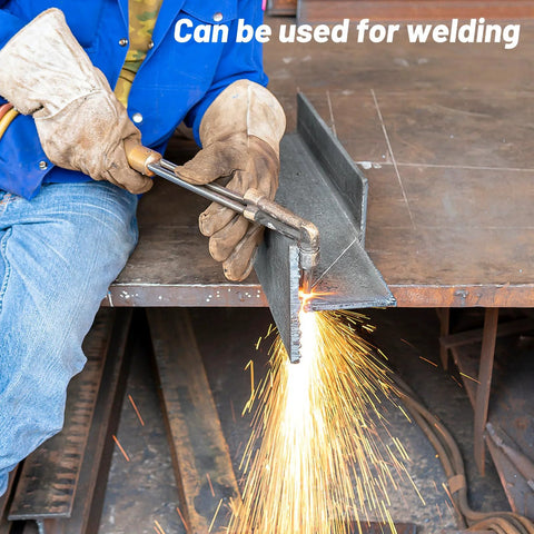 Stainless steel flat bar being welded by a worker; brushed finish on metal workbench.