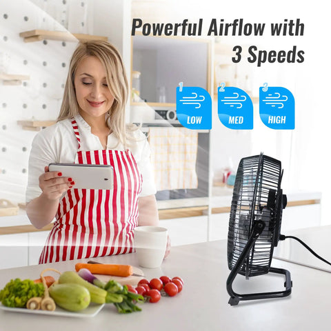 Woman in kitchen near 9 Inch Floor Fan With 3 Speed Settings, Portable Metal Design, Quiet Operation