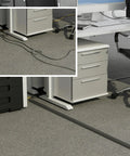 No Sweat Six Foot Floor Cable Cover And Wire Protector Channel in office setting, flexible PVC builds hiding cords on carpet.