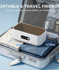 Top Shelf 49Khz Ultrasonic Cleaner With Roomy 650Ml Stainless Steel Tank and Digital Timer in a suitcase with clothes.
