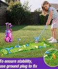 Toddler playing golf with Toddler Golf Set For Kids Ages 2 To 5 With 4 Plastic Clubs, 8 Soft Balls, Putting Mat and Pink Golf Cart Toy