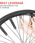 Hands using levers from Grab-And-Go 8-In-1 Bike Repair Kit With CO2 Inflator And Cartridges, Saddle Bag, Tire Patch Kit And Levers