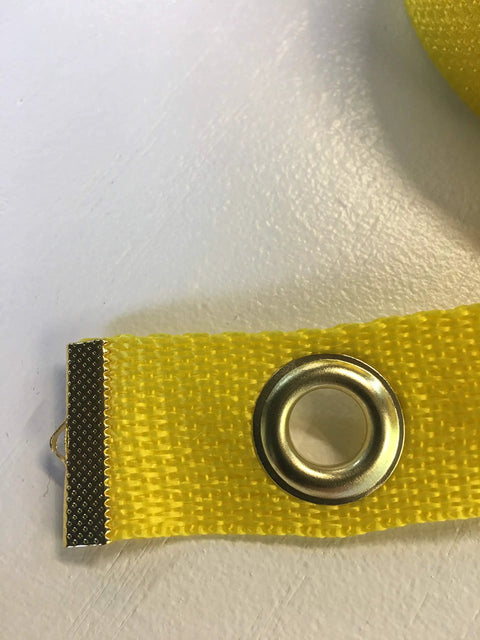Close-up of bright yellow grommeted strip from 12 Pole Weave Pole Placer For Dog Agility Training Ensures Even Spacing Every Run