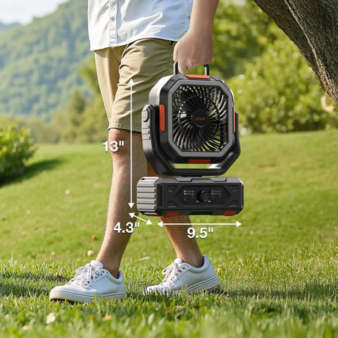 Man holding 30000mAh Portable Camping Fan With Remote And LED Lantern outdoors, dimensions 13x9.5x4.3 inches, cordless convenience.