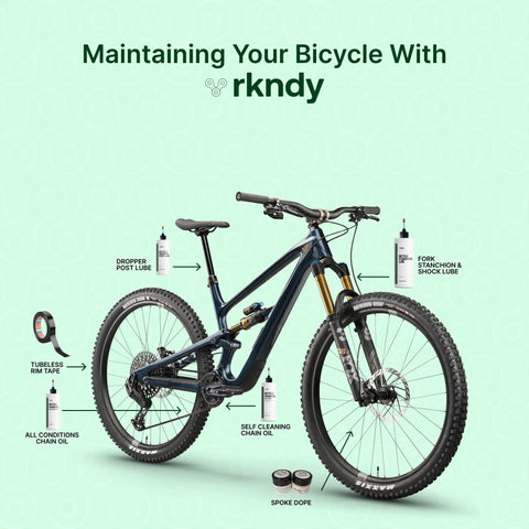 Bike with labeled maintenance products, featuring fork stanchion and shock lube for bikes keeps suspension smooth like butter reducing stiction