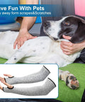 Arm Protection Sleeves Level 5 Cut Two Pairs Heat Resistant Protectors close-up with person holding a black and white dog.