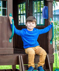 Child sitting in playhouse with Blue Pirate Ship Wheel Toy Telescope And Telephone Playground Accessories Bundle visible