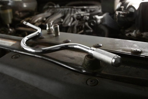 Beefy Three Eighths Inch Drive Speeder Handle, 16.75 Inch Length on car engine, chrome finish, showing ball detent end