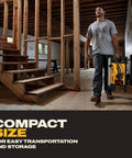 Man carrying Built Like A Tank Portable Table Saw Equipped With Sturdy Rolling Cart and Premium Steel Blade in a construction site.