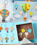 Color Your Own Hot Air Balloon Keychains Kit With 24 Wooden Blanks, 12 Styles, colorful DIY craft set for kids and adults shown in use.