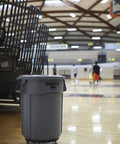 Heavy Duty 32 Gallon Trash Can Dome Lid With Self Draining Channels Gray Snap Lock Secure Fit in gym setting