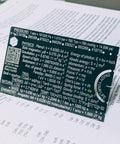 Mini 3 Inch Metal Science Ruler And Multitool With Metric And Imperial Scales Protractor And Compass on open textbook