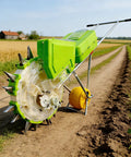 Go-To Dual-Hopper Precision Garden Seeder With Wheel And All-In-One Seed Sower And Fertilizer Applicator on a dirt path