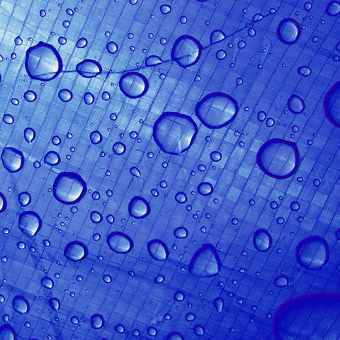 Close-up of Blue 10 X 20 Ft Waterproof Tarp Cover With 4 Mil Thick Poly Material showing water droplets on the surface