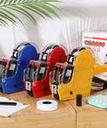 Three Set Price Gun Labeler Kit With Fifteen Thousand Blank White Labels And Three Ink Rolls Date Gun on a wooden table