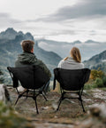 Two people sitting on Adjustable Height Lightweight Camping Chair With Carry Bag And Side Pockets overlooking mountains