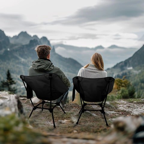 Two people sitting on Adjustable Height Lightweight Camping Chair With Carry Bag And Side Pockets overlooking mountains