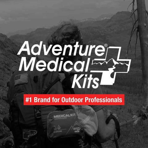 Adventure Medical Kits Mountain Series Backpacker Medical Kit, 96 pieces, blue/orange, attached to a hiking backpack.