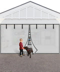 Hands Free Magnetic Garage Door Screen In Privacy Silver, 9 By 7 Feet installed on garage, child and dog nearby