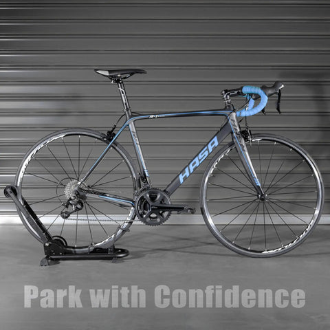 Foldable Bike Stand Floor Rack For MTB And Road Bikes With Quick Fold Design Durable Portable Garage Storage Fits Up To Two Point Four Inch Tire Width Easy Push In Front Holder Sturdy Bike Parking Rack holding a road bike