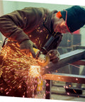 Heavy Duty Hearing Protection Earmuffs Built To Crush Nasty Workshop And Factory Noise Solid Sound Insulation headband worn by worker using a grinder.