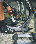 Cyclist using LineUp Portable Folding Bike Stand For 20 To 29 Inch Wheels, Lightweight Aluminum, on gravel surface