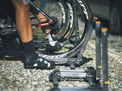 Cyclist using LineUp Portable Folding Bike Stand For 20 To 29 Inch Wheels, Lightweight Aluminum, on gravel surface