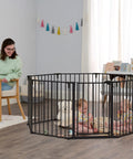 Heavy Metal Super Wide Baby Gate Expands To 192 Inches For Massive Openings with toddlers playing inside an enclosure.