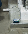 Wet Switch Flood Detector With Hydrophilic Pad And Integrated Feet near HVAC system on concrete floor