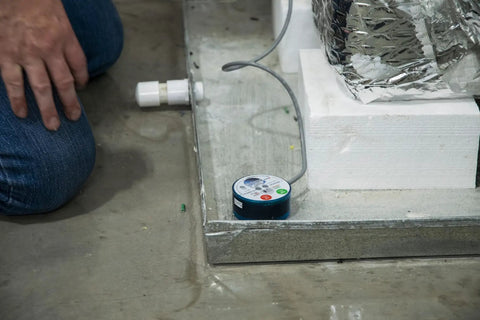 Wet Switch Flood Detector With Hydrophilic Pad And Integrated Feet near HVAC system on concrete floor