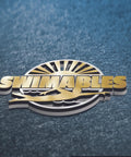 Gold and silver Swimables logo on textured blue background with swimmer silhouette and sun rays