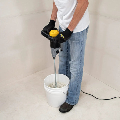 Person using 120 Volt 2 Speed Power Mixer with Mixing Paddle for thinset mortar and grout, lightweight ergonomic grip, 1300W electric cement mixer.