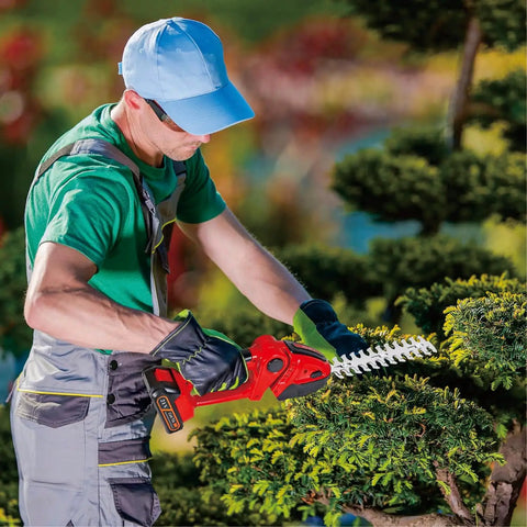 Person using Cordless 2-In-1 Hedge Trimmer And Grass Shears, Handheld Shrubbery Cutter with 9 Inch Trimming Blade in garden