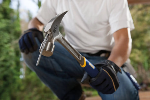Person holding Forged Steel Claw Hammer 20 Oz Workhorse With ProTouch Grip For Comfort And Less Hand Fatigue, outdoor setting