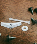 Heavy Duty Carbon Steel Drywall Anchors And Hollow Wall Expansion Screws With Petal Umbrella Clips M5 By 60 Assortment Kit parts on wood.